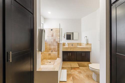 a bathroom with a toilet and a sink at Cabo Villa - G3 Punta Arena - 3 Bed 2.5 Bath in Cabo San Lucas