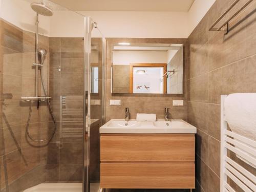 a bathroom with a sink and a shower at Haus Ganbei L in Donnersbachwald