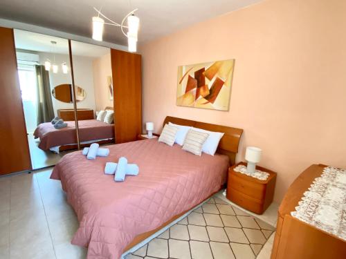 a bedroom with two beds and a mirror at Sea view home away from home in St. Paul's Bay