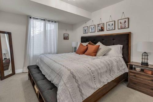 a bedroom with a large bed and a window at Park City Cozy Cottage in Heber City