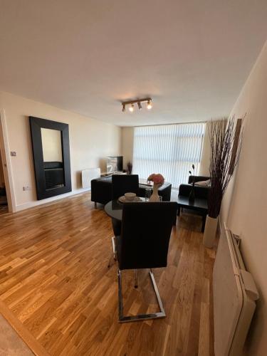 a living room with a table and chairs in it at Cardiff City Center - with FREE Parking in Cardiff