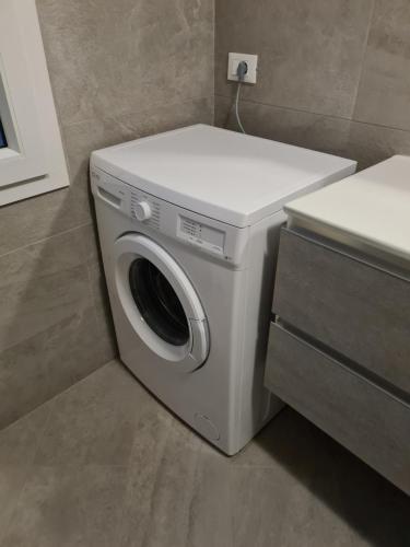 a washer and dryer in a small bathroom at Venezia Beach in Chioggia