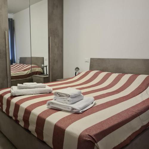 a hotel room with a bed with towels on it at VENEZIA Beach in Chioggia