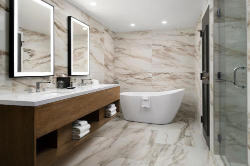 a bathroom with a tub and a sink and mirror at The Westin Lake Las Vegas Resort & Spa in Las Vegas