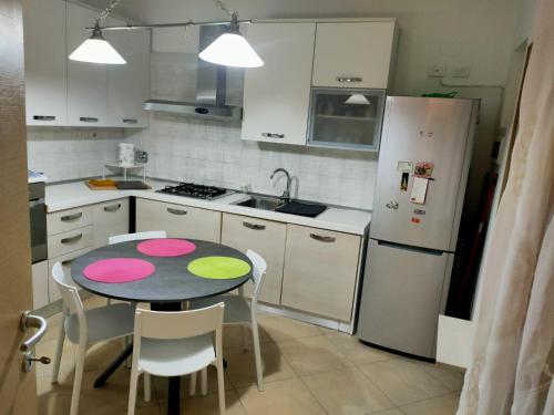 a small kitchen with a table and a refrigerator at Stefy House in Lastra a Signa