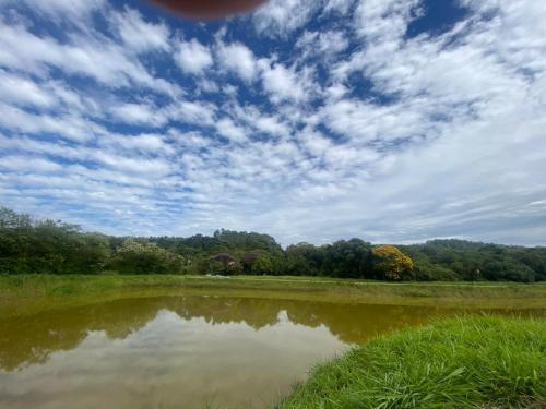 a large body of water with a cloudy sky at Vila Eco Mobili in São Roque