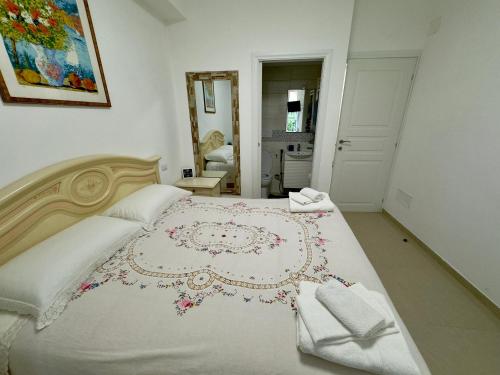 a bedroom with a large white bed with a rug on it at Azadi Center Apartment in Rome