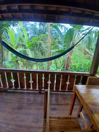 a view from the porch of a house with a hammock at Green Escape in Tetebatu