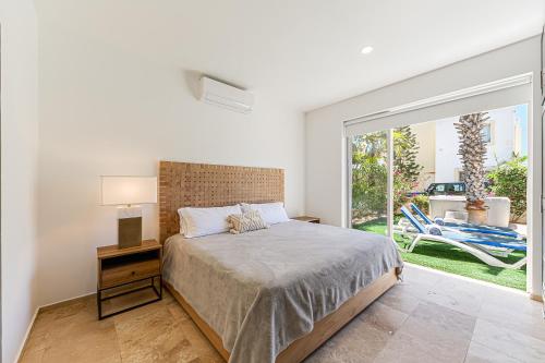 a bedroom with a bed and a large window at Cabo Villa - G3 Punta Arena - 3 Bed 2.5 Bath in Cabo San Lucas