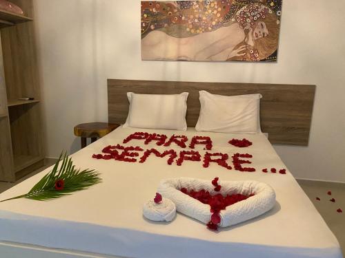 un letto con un felice anno nuovo scritto sopra di Pousada Águas de Tamandaré a Tamandaré