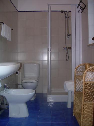 a bathroom with a toilet and a shower and a sink at Agriturismo Villa Luca in SantʼAgata di Militello