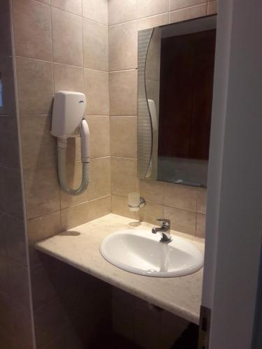 a bathroom with a sink and a mirror at Anastasia Village in Nikiana
