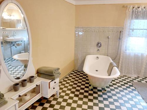 a bathroom with a tub and a sink and a mirror at 30qm Studio Rosenheimer Innenstadt in Rosenheim