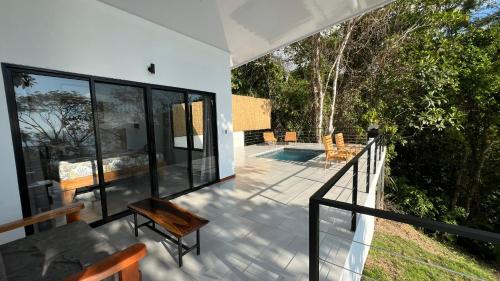 a balcony of a house with a view of a pool at Canavida Villas & Resort in Uvita