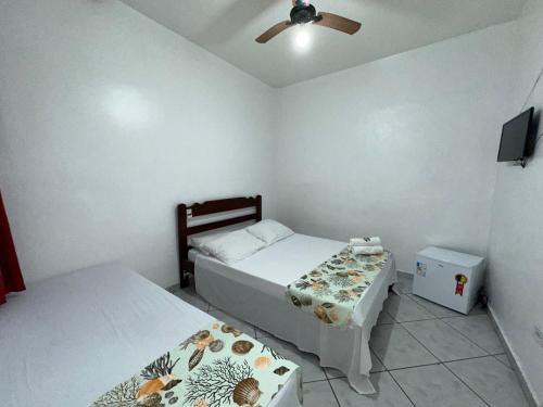 Säng eller sängar i ett rum på Pousada Suíte Verde Mar