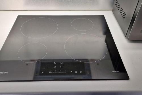 a close up of an appliance with four circles on it at Modern 1 Bed Apartment With Secure Gated Parking in Bradford