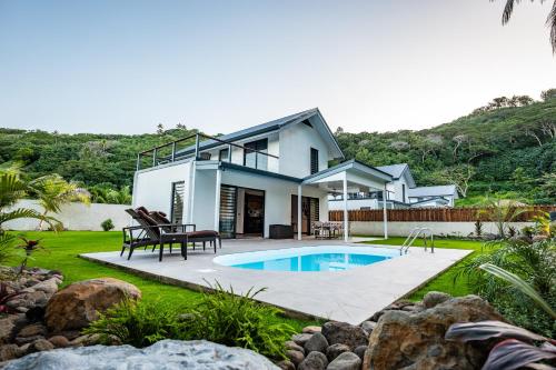 a house with a swimming pool in the yard at Secret Pearls by Matira Beach in Bora Bora