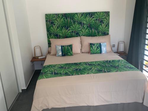 a bedroom with a large bed with a mural on the wall at Secret Pearls by Matira Beach in Bora Bora