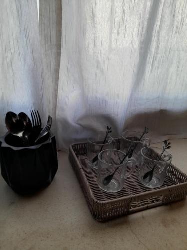 two baskets with utensils next to a curtain at casa alpina in Navarro