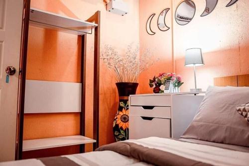 a bedroom with a bed and a dresser and a mirror at Hostal Sol y Luna 