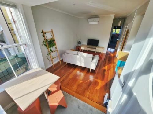 a living room with a white couch and a table at City Edge Nest in Wellington