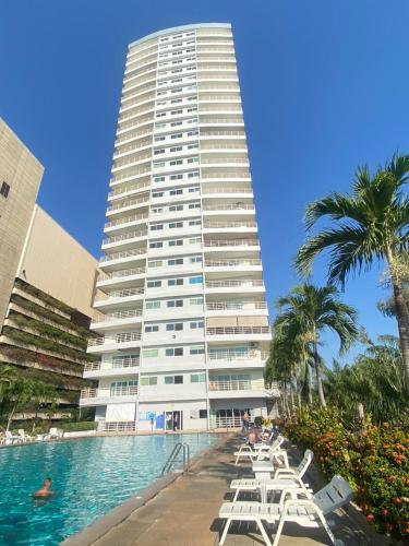 a tall building with a swimming pool in front of it at View Talay6 Mark Apartments in Pattaya