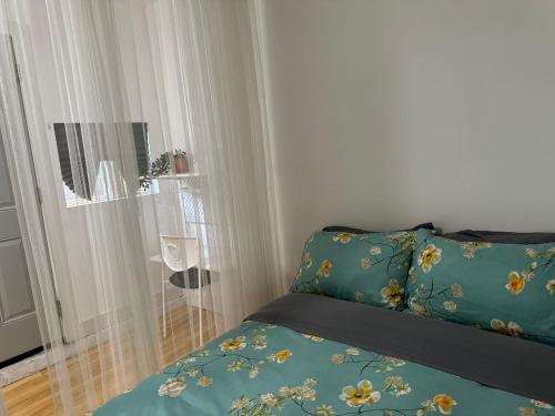 a bedroom with a bed with a blue comforter at Hummingbird's Retreat-One bedroom-private bath-private entry door in Las Vegas