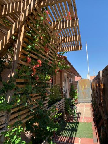 a wooden pergola with flowers on a house at Hummingbird's Retreat-One bedroom-private bath-private entry door in Las Vegas