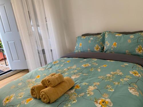 a stuffed teddy bear sitting on a bed at Hummingbird's Retreat-One bedroom-private bath-private entry door in Las Vegas