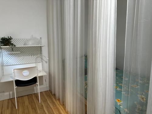 a room with a desk and a curtain at Hummingbird's Retreat-One bedroom-private bath-private entry door in Las Vegas