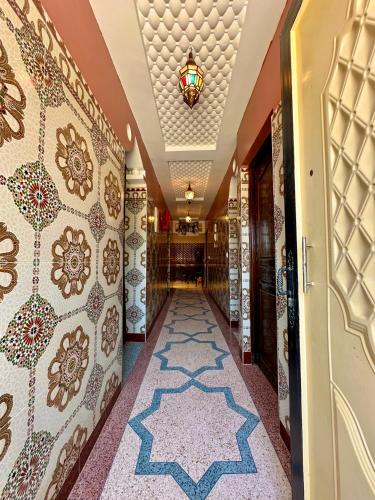 a hallway with moroccan tiles on the walls at Aourir soul hostel in Aourir