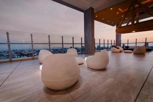 a room with white chairs on top of a building at Loft Javier Prado in Lima