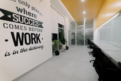 a hallway with a sign that reads only disease wheresuccess comes before work is in at Loft Javier Prado in Lima