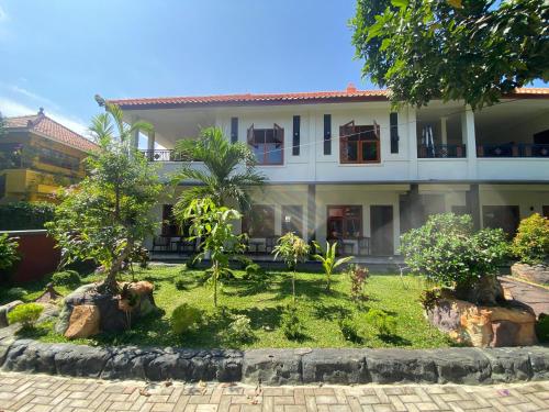 a house with a garden in front of it at Mango Guesthouse in Pangandaran