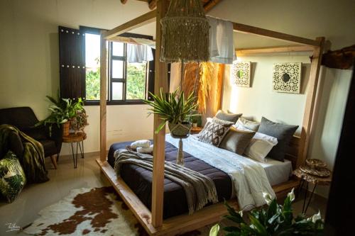 a bedroom with a canopy bed in a room at Finca Hotel el Diamante in Calarcá
