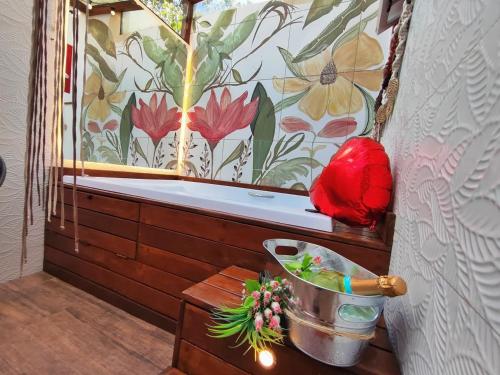 a bathroom with a window with a flower mural at CasinhaPiri in Pirenópolis