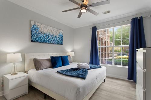 a bedroom with a bed and a ceiling fan at Royale Blue in Kissimmee
