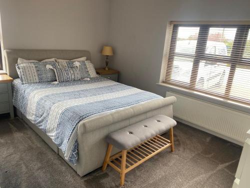 a bedroom with a bed and a window at Thornstown Gate Cottage in Portglenone