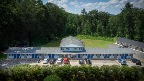 an aerial view of a building with cars parked in a parking lot at Granby Motel in South Hadley