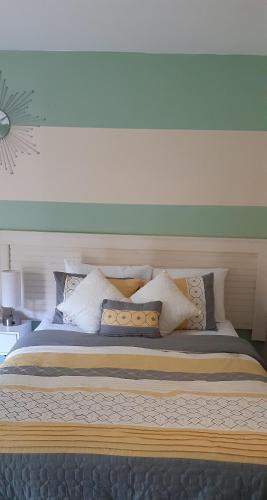 a bedroom with a large bed with pillows at Riverside Bed and Breakfast in San Juan