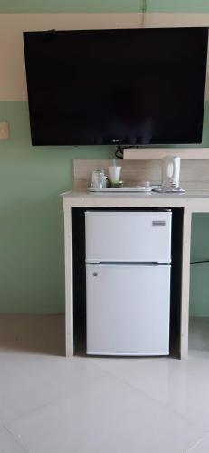 a white table with a tv on top of it at Riverside Bed and Breakfast in San Juan
