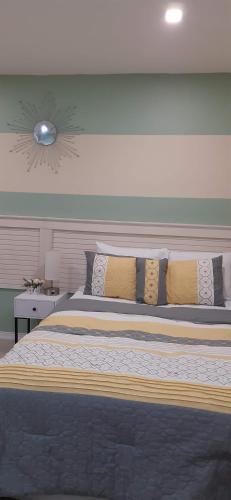 a bedroom with a large bed with pillows at Riverside Bed and Breakfast in San Juan