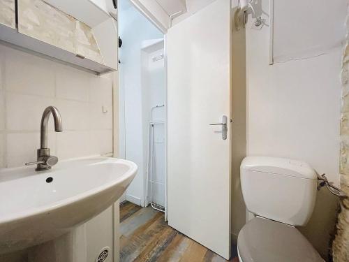 Baño blanco con lavabo y aseo en Studio La Rochelle, 1 pièce, 2 personnes - FR-1-710-26, en La Rochelle