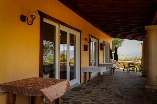 a porch of a house with a table and chairs at Quinta Estrella in Valle de Guadalupe