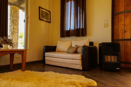 a living room with a couch and a window at Quinta Estrella in Valle de Guadalupe