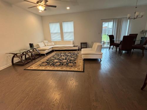 a living room with a couch and a table at Huge Master Suite Attached Bath, Fridge, TV 20 Mins To Tesla in Manor