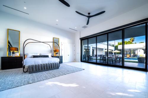 a bedroom with a bed and large glass windows at Old Town Scottsdale Luxury Villa - Heated Pool, Spa, Rooftop Deck, Sauna, Speakeasy in Scottsdale