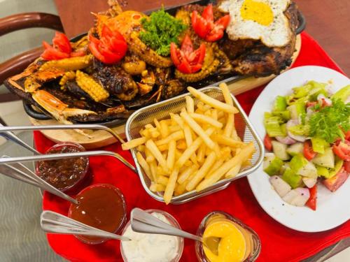 a red tray of food with french fries and other foods at ROYAL GRAND PARADISE RESORT AND TOURS NEAR COLOMBO in Kelaniya