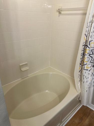 a white bath tub in a bathroom at Vashay's Lovely vacation pad at Disney in Davenport