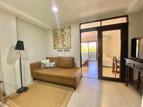 a living room with a couch and a sliding glass door at Paradores de Vigan in Vigan